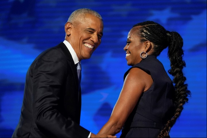 Former President Barack Obama hugs former first lady Michelle Obama as he is introduced during the Democratic National Convention in Chicago, Aug. 20, 2024. (AP Photo/Erin Hooley)